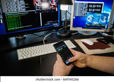 Man Holding A Phone With A Bitcoin Exchange Rate