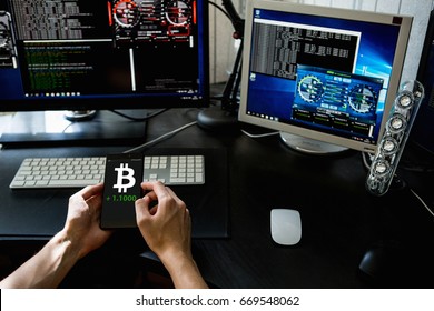 Man Holding A Phone With A Bitcoin Exchange Rate