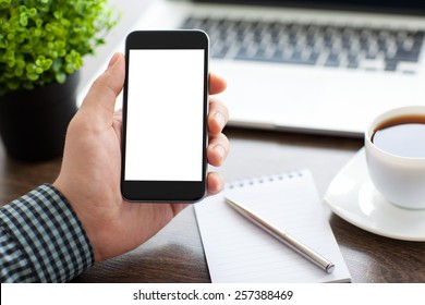 Man Holding A Phone With Isolated Screen Over The Desk In The Office