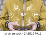 Man holding phone and using virtual screen sees text: NLP. NLP Natural Language Processing neural network concept. NLP Speech Recognition, Conversational AI and Computational Linguistics Technology.