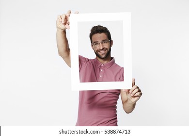 Man Holding Picture Frame To Camera, Portrait