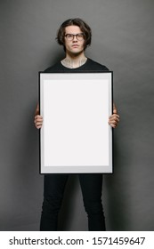 Man Holding A Picture Frame Or Poster For Mock Up Wearing Black Clothes