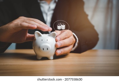 Man Holding A Piggy Bank With His Hand Saving Money And Planning For Profit And A Better Quality Of Life For The Future. For Family And Work.