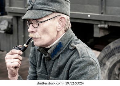 Man Holding A Pipe. Old Military Man. Retro Military Man. Smoking Addiction. Tobacco Pipe. Vinnitsa. Ukraine. 10.12.2019.