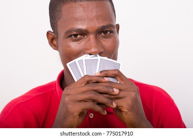 Man Holding Playing Cards Sticking To Face