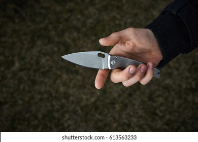 Man Holding Pocket Knife In Hand Close Up