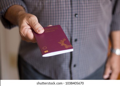 Man holding the Portuguese Passport by hand