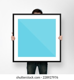 Man Holding Poster Mockup Template With Frame On White Backgroun