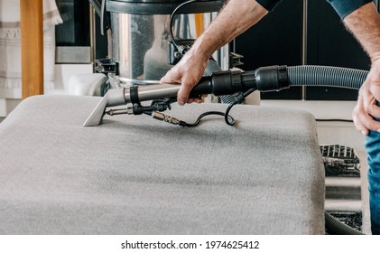 Man Holding Professional Deep Clean Machine And Cleaning Couch In Living Room In Apartment 