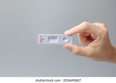 man holding Rapid Antigen Test kit with Positive result during swab COVID-19 testing. Coronavirus Self nasal or Home test, Lockdown and Home Isolation concept