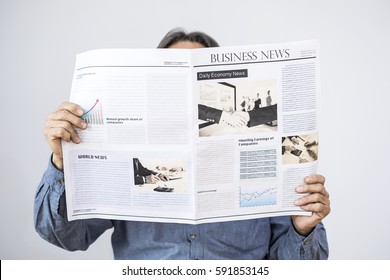 Man Holding Reading Newspaper On Gray Background