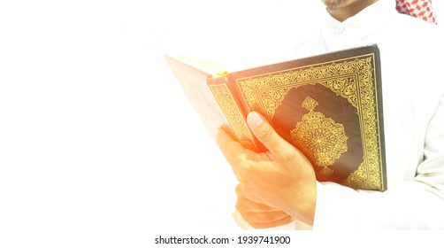 Man Holding And Reading Quran. Islamic Background.