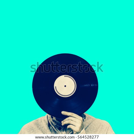 man holding record, isolated on green. art filter, music background