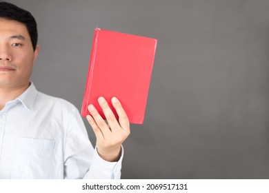 Man Holding Red Book In Hand