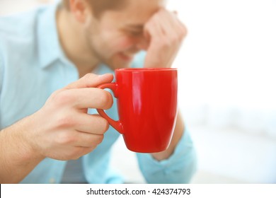 Man Holding Red Cup Of Coffee In Hand, Close Up