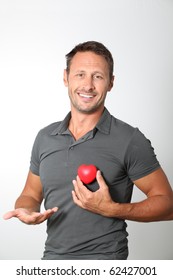 Man Holding Red Heart In His Hands