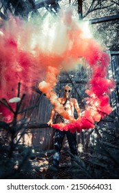 Man Holding Red And Orange Smoke Grenade