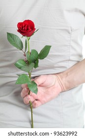 Man Holding A Red Rose Behind His Back