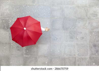 Man holding a red umbrella  - Powered by Shutterstock