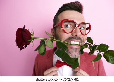 Man Holding A Rose In Mouth 
