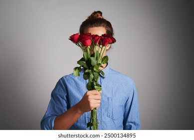 Man, holding roses and love with gift, romantic gesture and present on gray studio background. Person, mockup space and model with flowers, natural and organic with gratitude, kindness and trust - Powered by Shutterstock