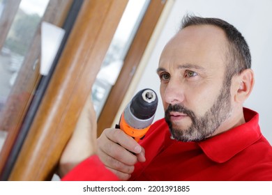 Man Holding A Rotary Drill