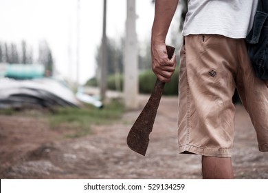 Man Holding Rusty Machete.