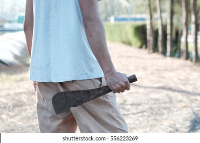 Man Holding Rusty Machete.