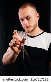 Man Holding Scissors In His Hand