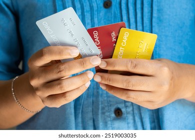 Man holding several credit cards and he is choosing a credit card to pay and spend Payment for goods via credit card. Finance and banking concept.