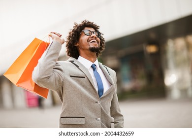 Man Holding Shopping Bags Looking Very Happy