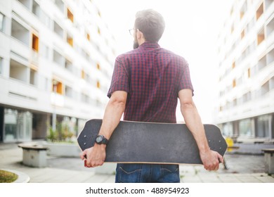 Man Holding Skateboard