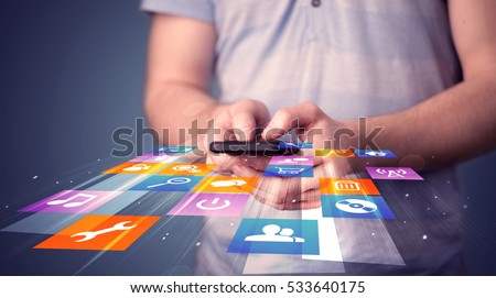 Man holding smart phone with colorful application icons comming out
