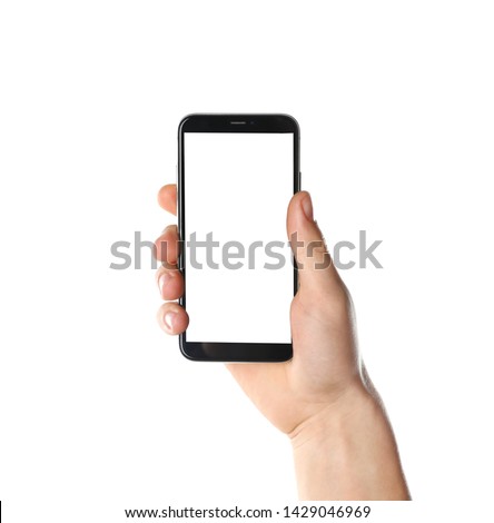 Man holding smartphone with blank screen on white background, closeup of hand. Space for text