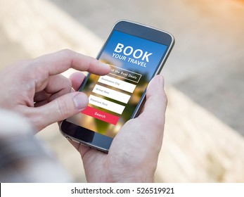 Man holding a smartphone with booking hotel travel app on screen.