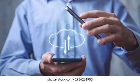 Man holding smartphone with a cloud computing upload and download.