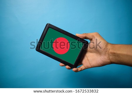 Man holding Smartphone with Flag of Bangladesh. Bangladesh Flag on Mobile Screen isolated On Blue Background