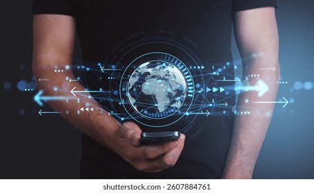 Man holding smartphone with glowing global hologram and data arrows overlay, on dark background, concept of smart tech and digital communication