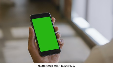 Man Holding A Smartphone (green Screen)