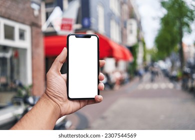 Man holding smartphone showing white blank screen at amsterdam - Powered by Shutterstock