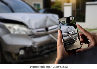 man holding smartphone and take photo of car accident call for help  damage to car after accident