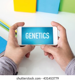 Man holding smartphone which displaying Genetics
