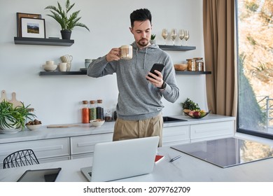 Man holding smartphone while reading message at home during the morning - Powered by Shutterstock