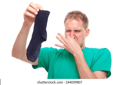 Man Holding Smelly Socks And Clogged Nose - Studio Shoot 