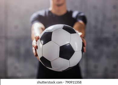 Man Holding Soccer Ball In His Hands