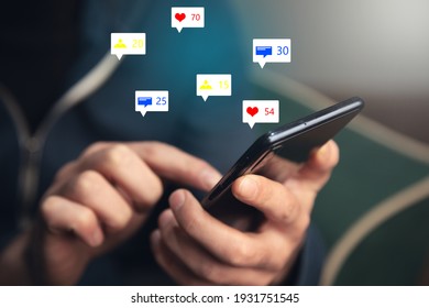 Man Holding Social Media Icons With Smart Phone