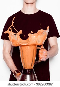 Man Holding Splashing Blender