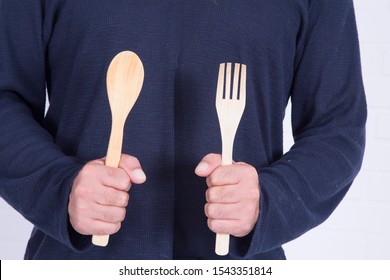 Man Holding Spoon And Fork Ready To Cook