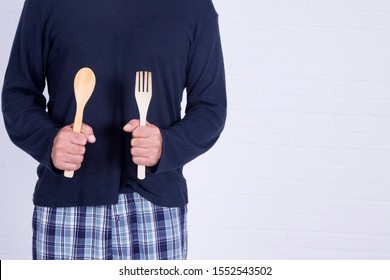 Man Holding Spoon And Fork Ready To Cook