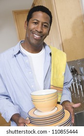 Man Holding Stack Of Washed Plates